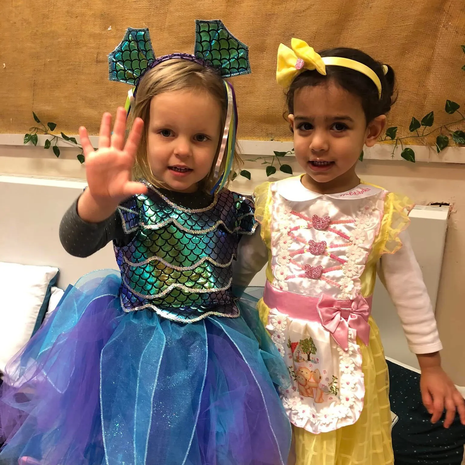 Nursery staff interacting with children at Tiny Tots